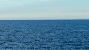 A peaceful and tranquil view of the vast ocean, showcasing a small boat, perfectly capturing natures stunning beauty photo