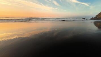 A breathtaking beach sunset that reflects beautifully on the calm waters, creating a truly peaceful atmosphere photo