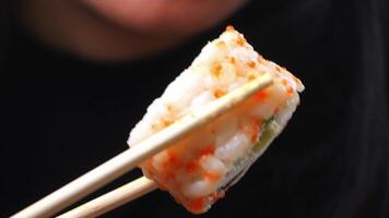 Enjoying sushi with chopsticks at a local restaurant video
