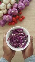 Freshly Shredded Purple Cabbage in a White Bowl on Wooden Surface video