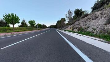 A picturesque and stunning view of a serene, peaceful road beautifully surrounded by lush greenery and trees photo