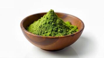 A heap of green matcha powder in a wooden bowl, isolated on a white background. Suitable for illustrating culinary, health, or tea-related theme. photo