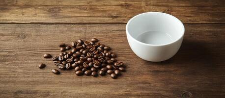 Coffee beans beside an empty white cup on wood photo