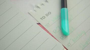 Organizing tasks with notes and a pen for productivity video