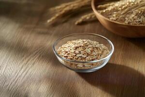 Rolled Oats in Glass Bowl on Wooden Table photo