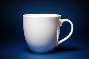 A single white ceramic mug on a blue background photo
