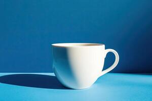 White Coffee Mug on Blue Background in Sunlight photo