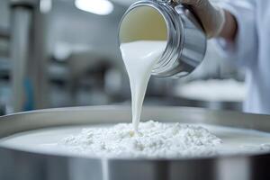 Milk being poured into a container of curd photo