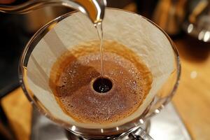 Pouring Hot Water Over Coffee Grounds In Filter photo