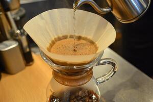 Hot water pouring into coffee filter brewing fresh coffee photo