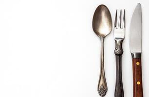 Silverware and knife on white background photo