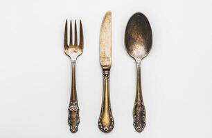 Antique Silverware Set Featuring Fork Knife and Spoon photo