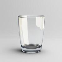 A single empty clear drinking glass sits on a gray surface photo
