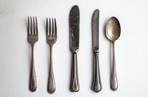 Antique Silverware Set Arranged on White Background photo
