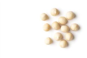Scattered Macadamia Nuts Isolated On White Background photo