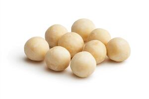 A group of round macadamia nuts on a white background photo