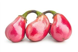 Three ripe red cashew apples clustered together photo