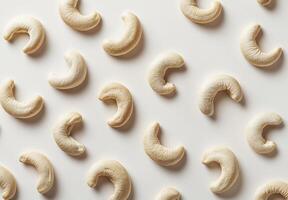 Cashew nuts arranged in a patterned design on a white background photo