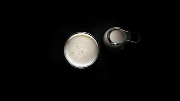 Glass of milk and a small milk creamer photo