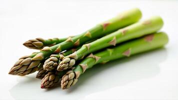 Several fresh green asparagus spears are isolated on a white background. For illustrating healthy food, vegetables, or cooking ingredients. photo