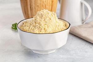 A bowl of flour next to a white pitcher photo
