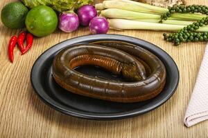 A plate of food on a table with vegetables and a snake photo