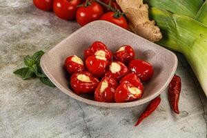A bowl filled with tomatoes and ginger photo