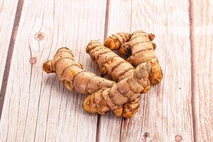 Ginger root on a wooden table photo