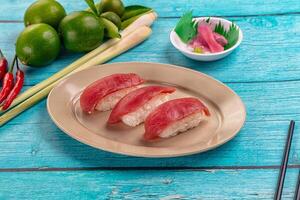 Sushi on a plate with chopsticks and limes photo