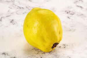 A lemon on a white marble surface photo