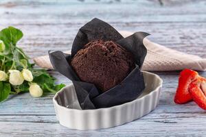 A chocolate cake in a white bowl with strawberries photo