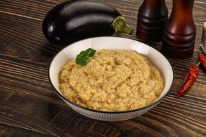 A bowl of eggplant dip with some spices and other ingredients photo