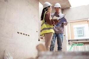 Engineers and architecture inspect and supervise the construction of building walls,51 photo