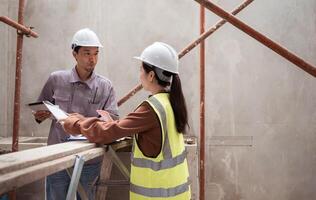 Engineers and architecture inspect and supervise the construction of building walls,24 photo