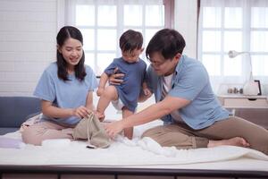 Asian kid and parents enjoying are having fun applying cream, powder and dressing up,143 photo
