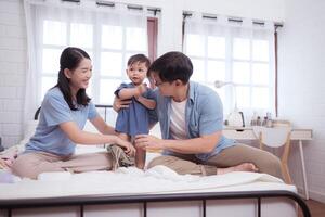 Asian kid and parents enjoying are having fun applying cream, powder and dressing up,107 photo