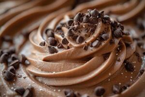 Chocolate ice cream topped with chocolate shavings is sitting on a wooden table photo