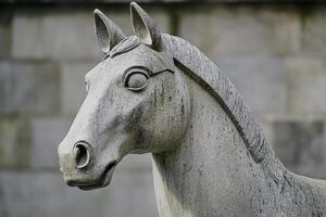 Close up of stone horse head statue looking left photo