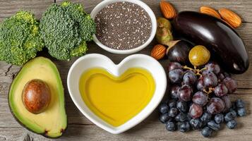Heart-shaped bowl of oil surrounded by healthy foods photo