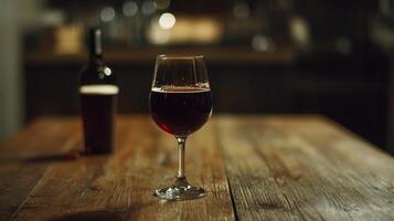 Red wine in a glass on a wooden table, blurred background photo