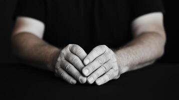 Hands clasped, grayscale, studio shot photo