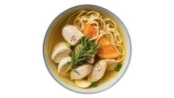 A bowl of chicken noodle soup with carrots and rosemary on a white background photo