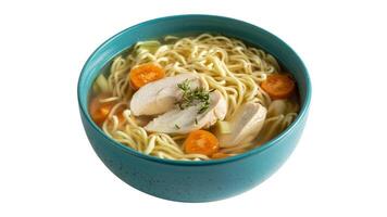 Close up of a bowl of chicken noodle soup with carrots and herbs on a white background photo