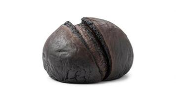 A single loaf of dark bread with two cuts on top on a plain white background photo