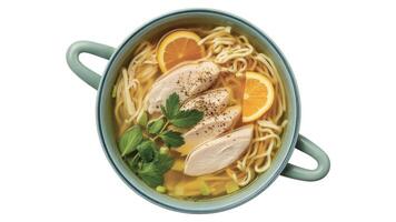 Overhead view of chicken noodle soup with orange slices and parsley in a blue bowl dishware photo