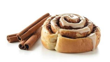 Close up shot of a cinnamon roll with white icing and cinnamon sticks on white photo