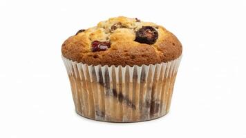 A single cranberry muffin in a white paper cup sitting on a plain white background surface photo