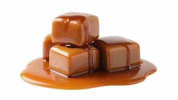 A close up of a stack of caramel candies with caramel sauce on a white background photo