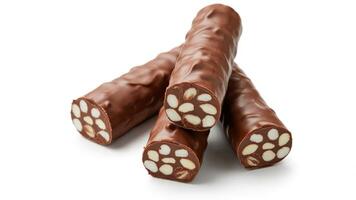 A close up of three chocolate covered almond logs stacked on a white surface in a studio shot photo