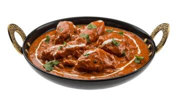 Close up of butter chicken in a black bowl with handles on a white background photo